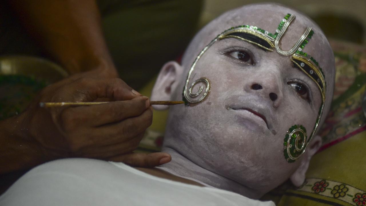 An artist getting his makeup done to take part in a religious procession during the 'Navratri' festival, in Prayagraj, Tuesday, Sept. 23, 2025. Photos Courtesy: PTI
